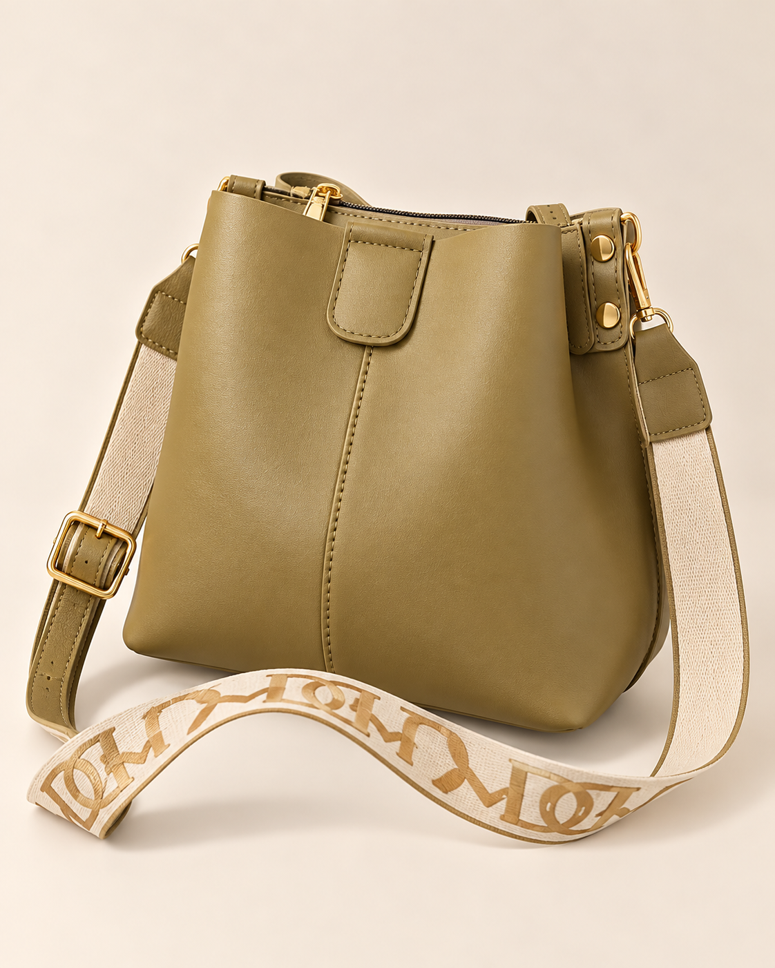 
The Cannes bucket bag in Tea Green, studio shot.